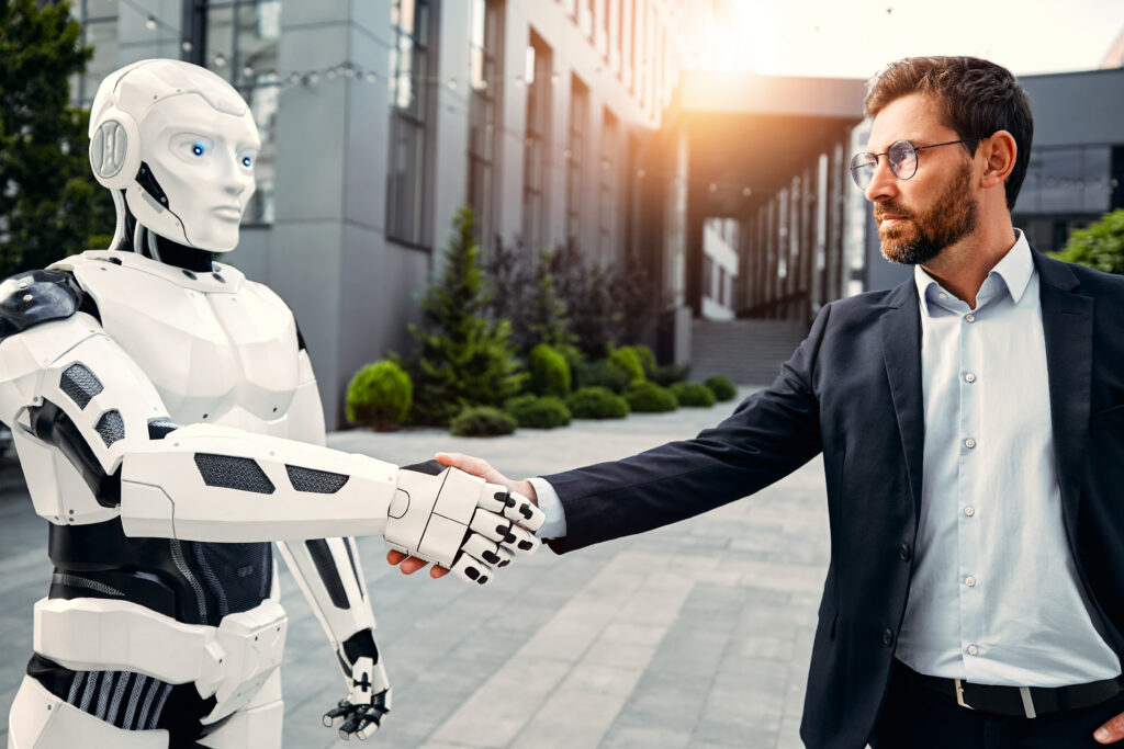A face-to-face marketing​ representative shaking hands with an AI robot.